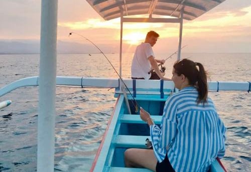 a man and woman waiting sunset for diving jurney on a boat