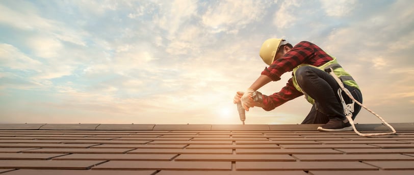 a man in a helmet and a helmet on a roof