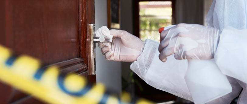 a person in a white lab coat and gloves holding a knife and a knife in