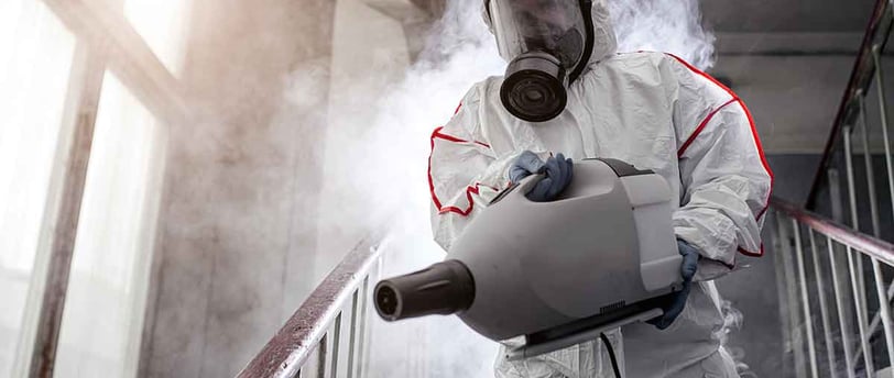 a man in a white suit and a gas mask