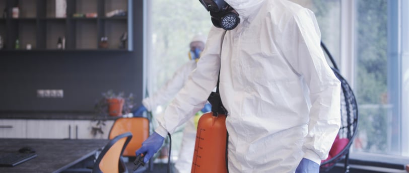 a man in a white suit and a gas canister