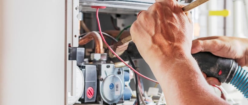 man servicing gas appliance