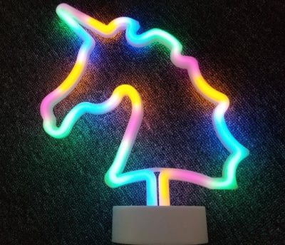a neon - lit unicorn shaped neon - up sign