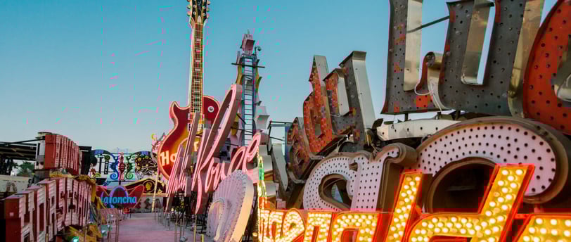 a large neon sign with a guitar in the foreground