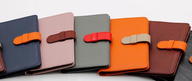 a group of four leather wallets with a leather case