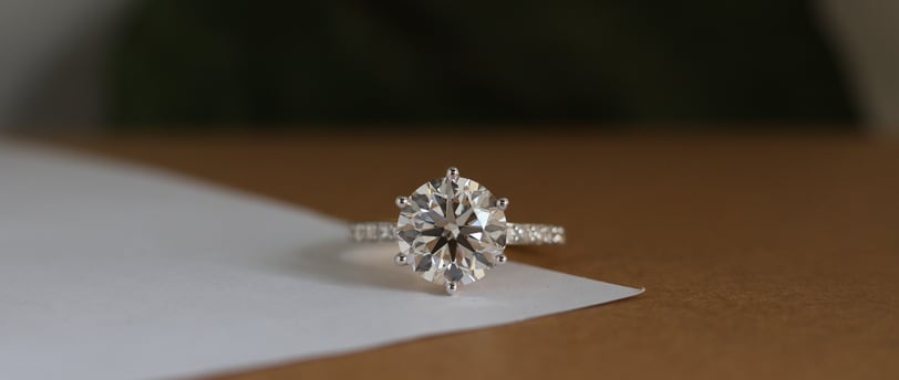 a cvd diamond ring with a cvd lab grown diamond ring on top of a paper