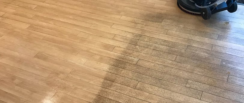 "Photo of a job in progress of a dirty vinyl floor in a small office in Daytona Beach, FL."