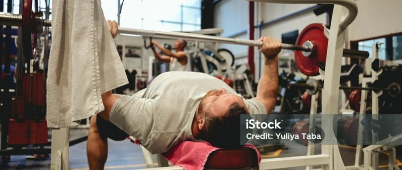 a man bench pressing some weight