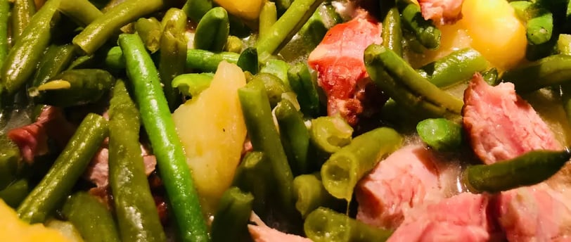 Close-up of southern style green beans with smoked meat and tender potatoes