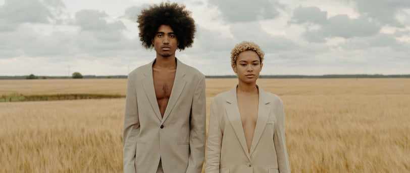 a man and woman standing in a field