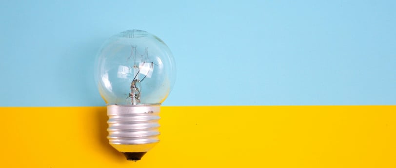 a light bulb bulb in a light bulb bulb on a yellow and blue background