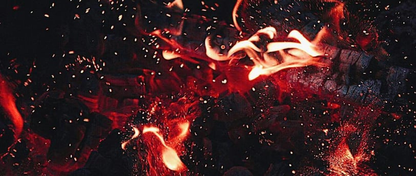 a fire burns in the night sky