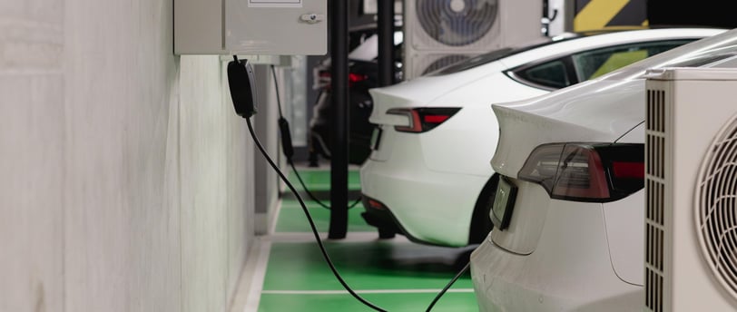 a car charging station with a car in the background