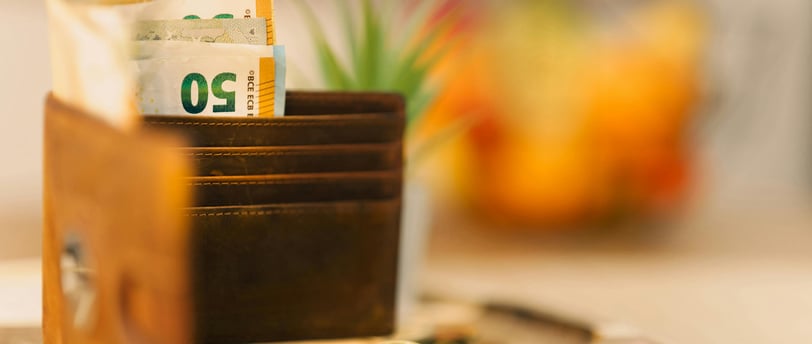 a wallet with money and coins in it