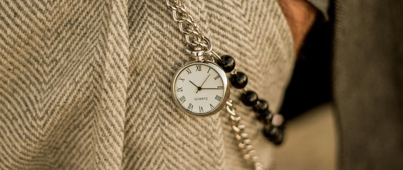 a person wearing a watch on a chain