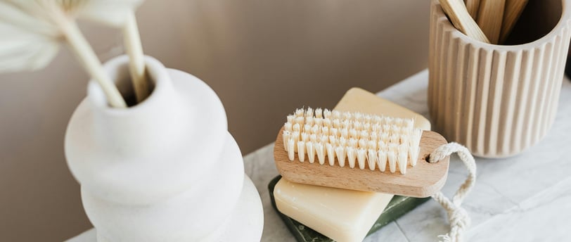 a wooden toothbrush and a toothbrush on a table