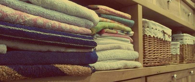 a bunch of towels and towels on a shelf