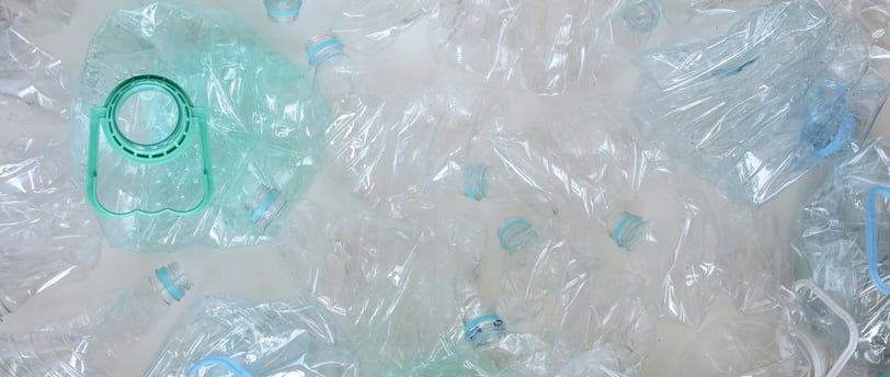a bunch of plastic bottles with plastic lids ready for recycling