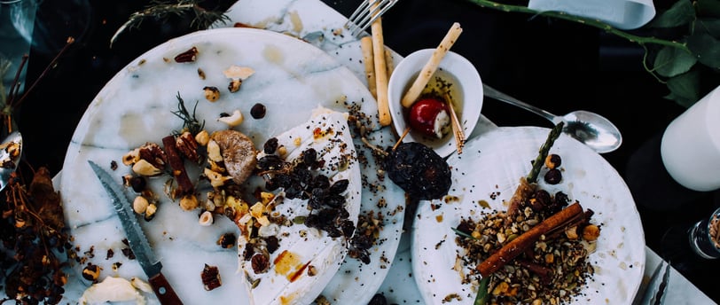 a messy table with a plate of food waste and utensils