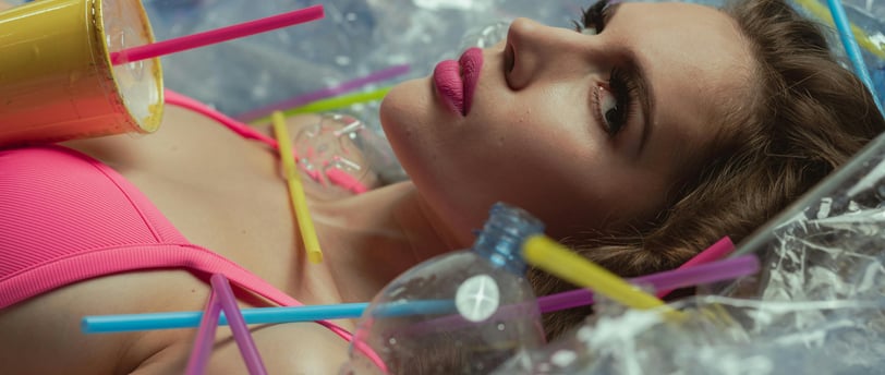 a woman in a pink bikinisuit laying on a plastic container
