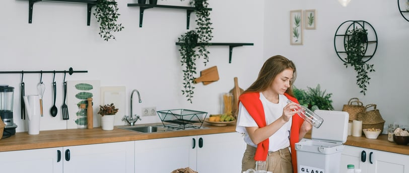 a woman in a red vest and white shirt is standing in a kitchen
