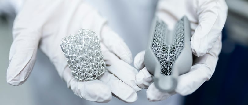 a person in white gloves holding materials to make batteries