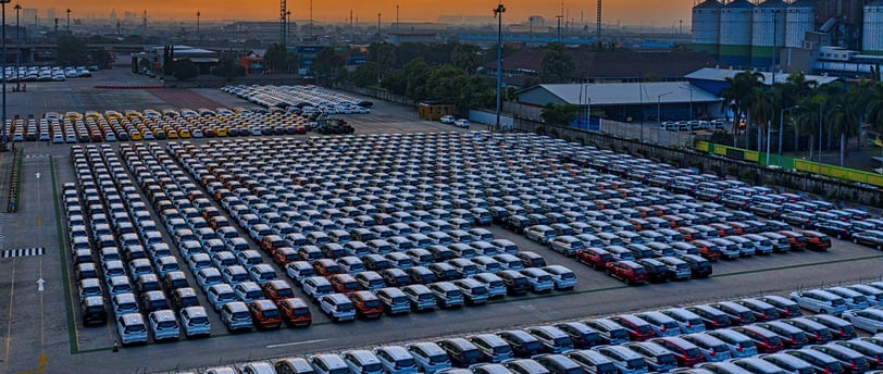 a parking lot full of electric cars parked in a parking lot
