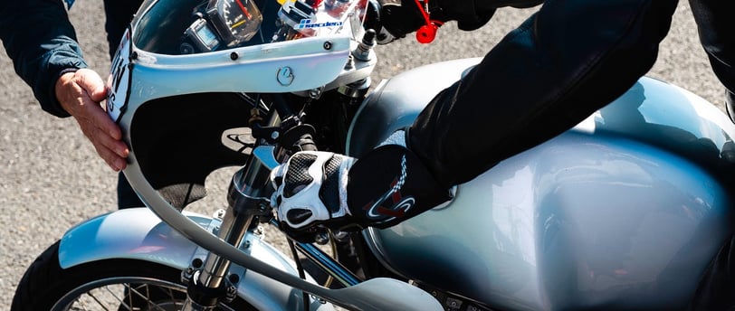 a person standing next to a motorcycle with a helmet on