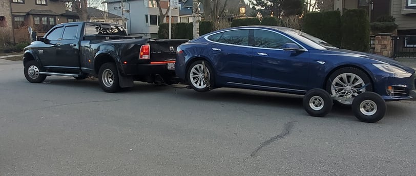Tesla Model S towed on wheel lift