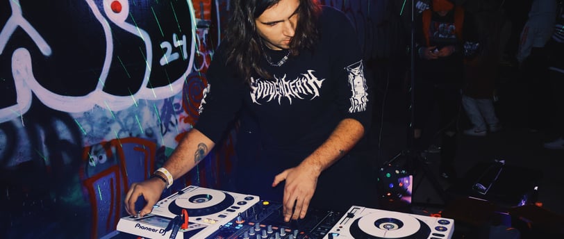 a man in a black shirt is playing a dj - creechur