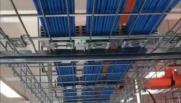 a large room with a lot of blue cables on the wire mesh cable tray