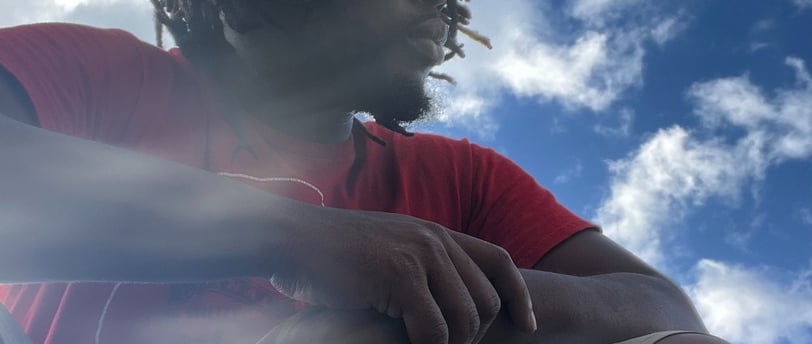 moody hunched over with crossed arms in a red shirt