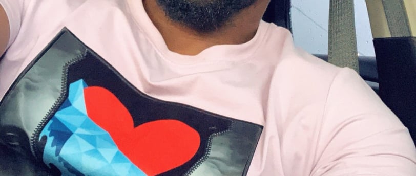 a man with a heart shaped t - shirt on his shirt