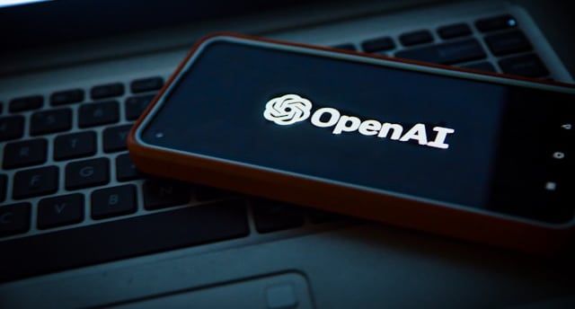 a cell phone with an open laptop on a laptop openai