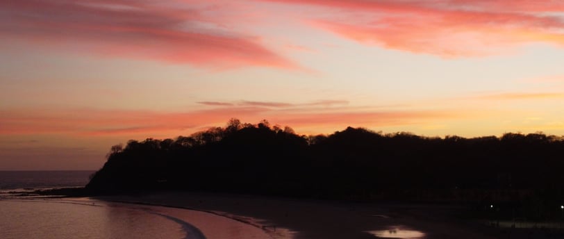 samara, costa rica beach with a sunset in the background
