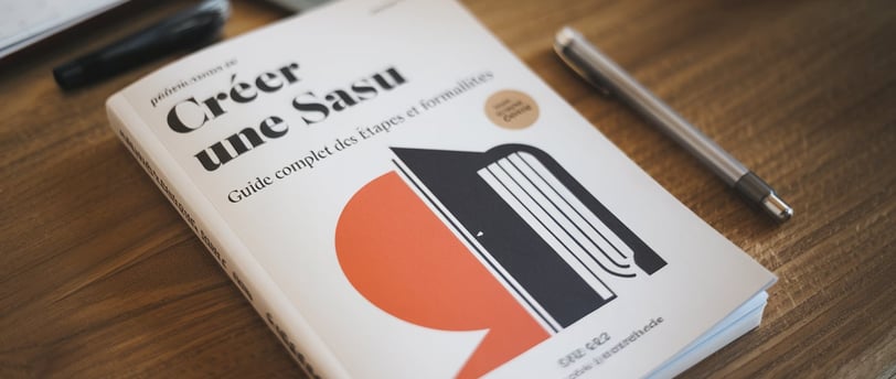 a book with a pen and a pen on a table LEGALIS Cabinet de Conseil