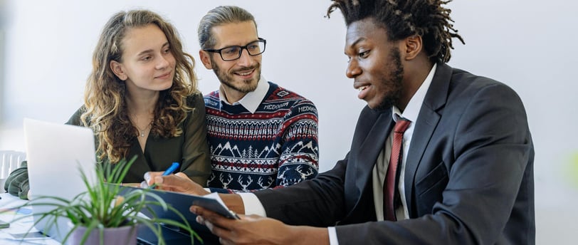 An agent explaining insurance benefits to a couple.