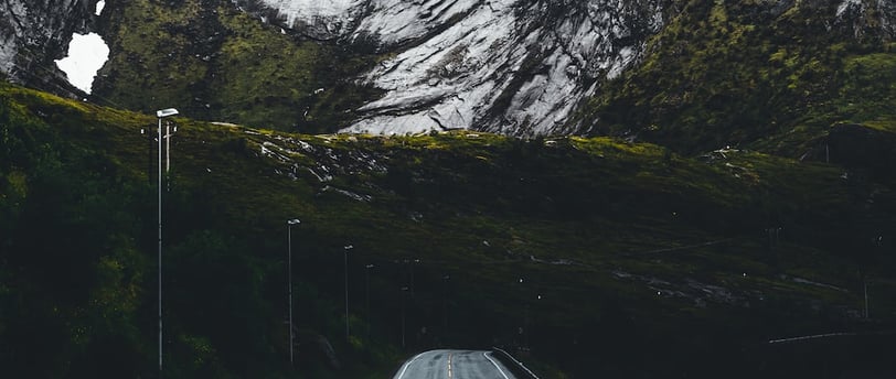 a road with a mountain in the background