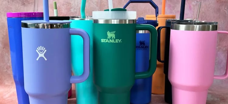 a variety of colorful colored mugs and tumblers