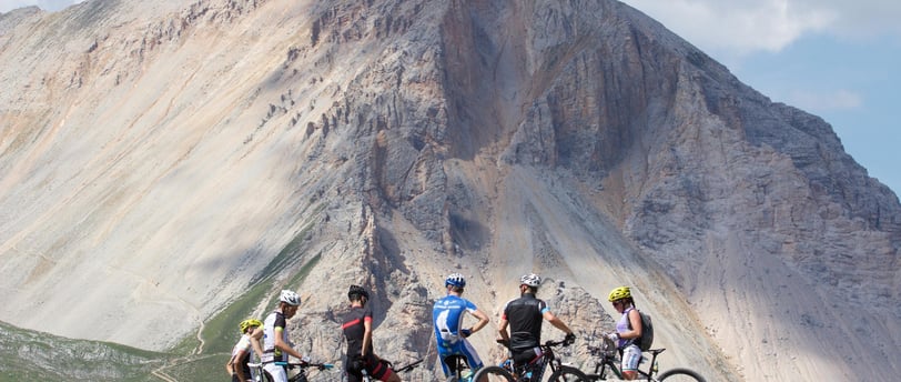 a group of people riding bikes on a mountain