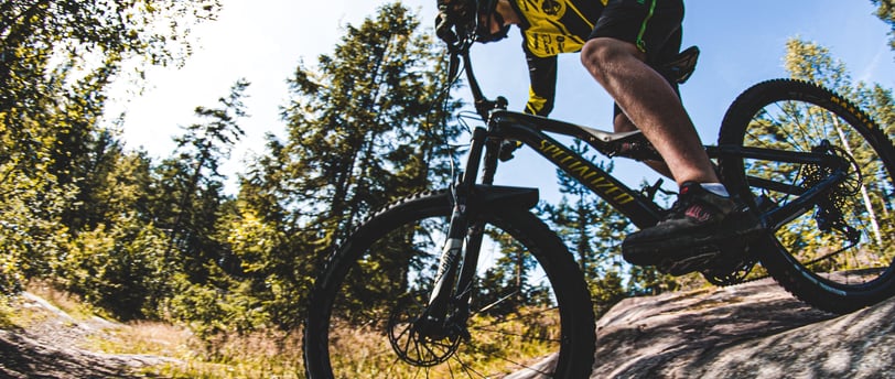 a person riding a bike on a rock wall