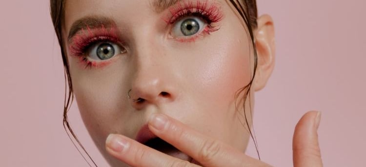 a woman with a pink eye makeup and a pink lip