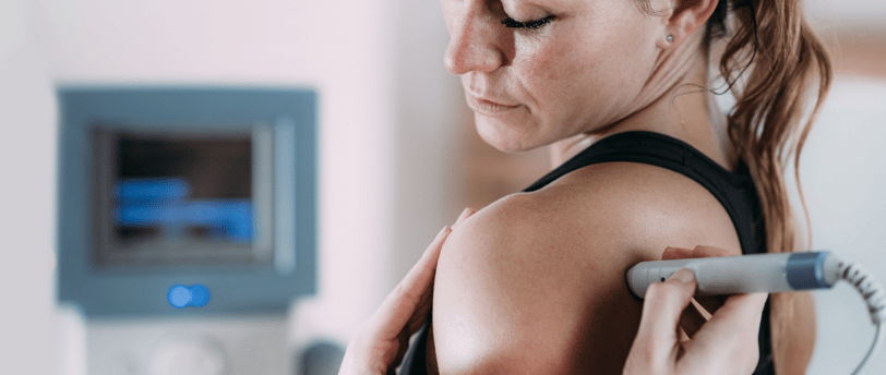 Laser therapy. Physical therapist treating patient's shoulder