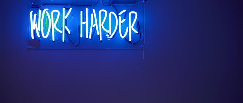 Motivational sign with the text "Work Harder" for inspiration