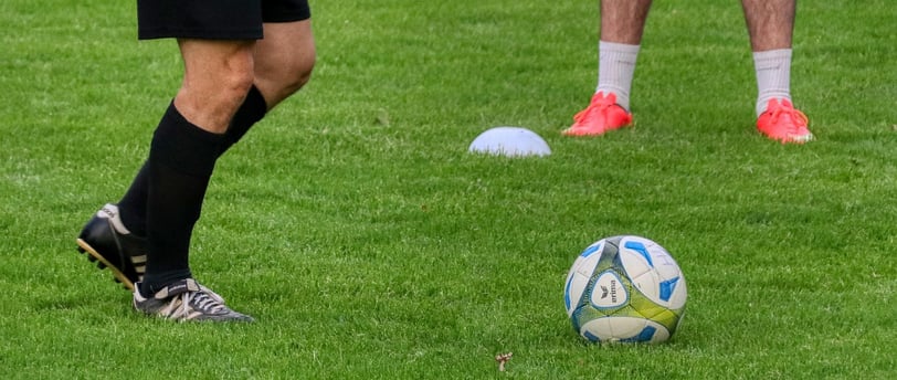 a soccer player is kicking a soccer ball