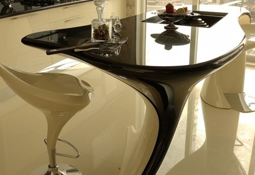 a modern kitchen with a table and chairs