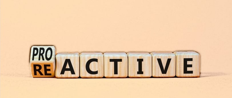 wooden blocks with the word changing from reactive to proactive