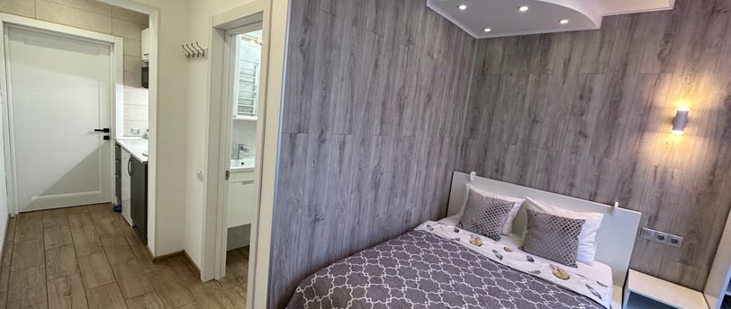 a bedroom with a bed and a bed in the middle of a room