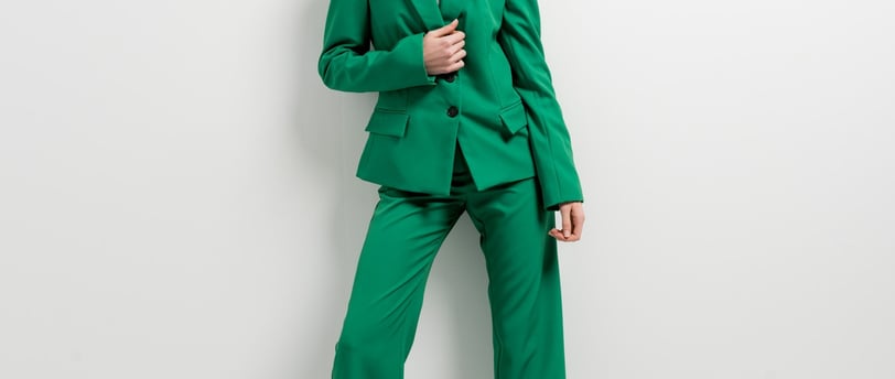 a woman in a green suit and heels