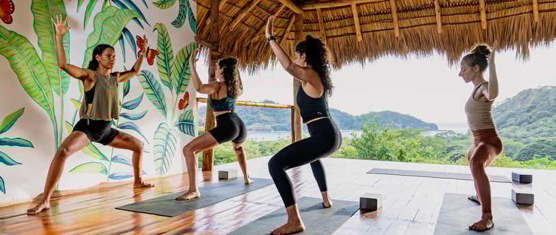 yoga class in yoga shala overlooking the ocean